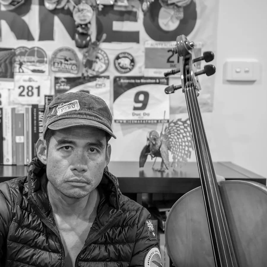 Duc Do with a cello in his studio