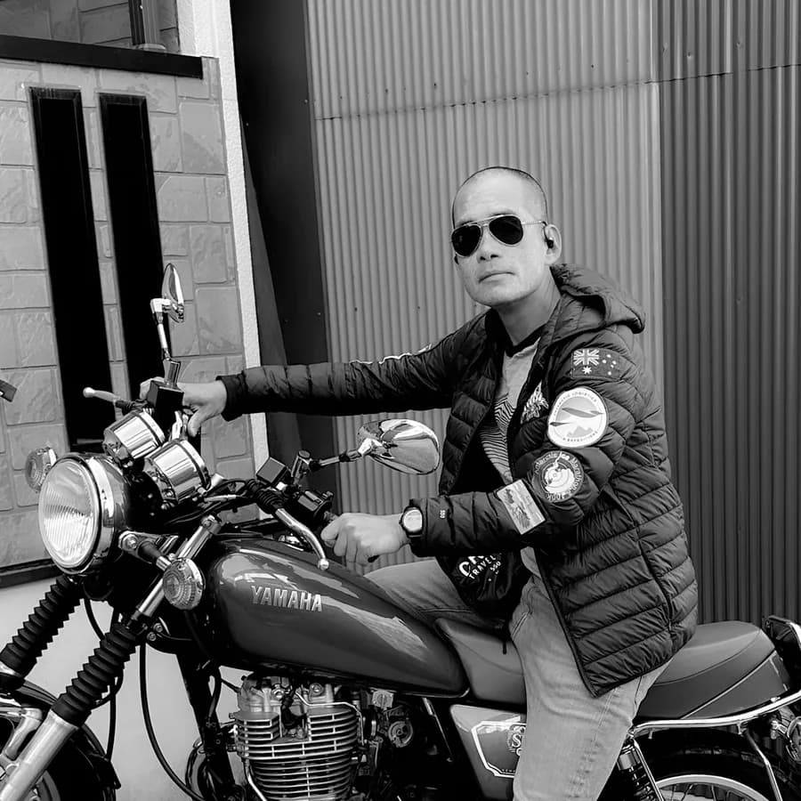 Duc Do seated on a motorcycle
